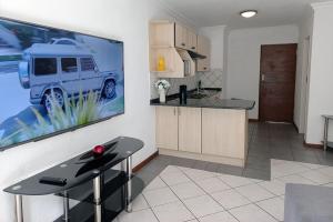 a kitchen with a large picture of a truck on the wall at Spacious Hatfield Apartment in Pretoria +8 photos