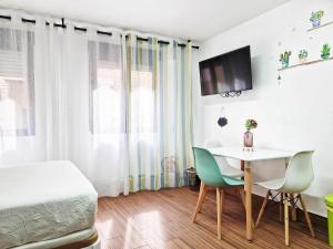 a bedroom with a bed and a table and chairs at Studio Simon 2 Murcia in Murcia