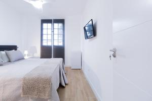Postel nebo postele na pokoji v ubytování Las Palmas Smart Rooms