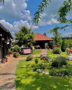 a garden with a brick path and a house at La vita e bella in Maglenča