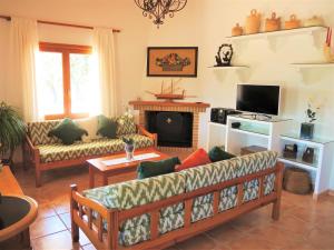 a living room with a couch and a fireplace at Can jeroni in Sant Llorenç des Cardassar