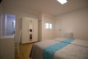 Postel nebo postele na pokoji v ubytování Las Palmas Smart Rooms