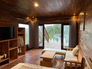 a living room with a couch and a tv at Batur Cliff Panorama in Baturaja