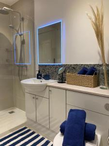 a bathroom with a sink and a mirror at The Queen’s apartments in London