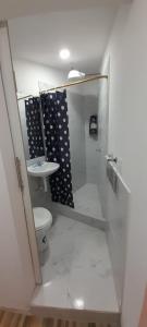 a bathroom with a toilet and a sink at Casa Apartamento en un lugar encantador de la Naturaleza in Hacienda Chichavo