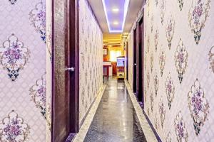 an empty hallway with a wall covered in wallpaper at Collection O Hotel Hemadri Residency in Bangalore