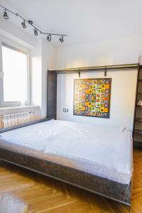 a large bed in a room with a window at Charming Apt next to Lazienki Park and City Center in Warsaw
