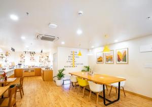 a kitchen and dining room with a table and chairs at Bloom Hotel - HSR Layout Sec 6 in Bengaluru