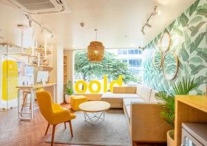 a living room with a couch and a table at Bloom Hotel - HSR Layout Sec 6 in Bengaluru