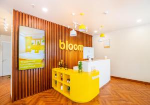 a room with a yellow table and a bed at Bloom Hotel - HSR Layout Sec 6 in Bengaluru