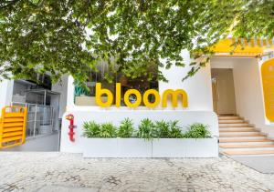 a building with a bloom sign on the side of it at Bloom Hotel - HSR Layout Sec 6 in Bengaluru