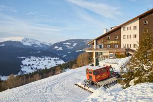 un tren está estacionado en la cima de una montaña cubierta de nieve en Nový pokoj Hotelu Emerich, en Pec pod Sněžkou