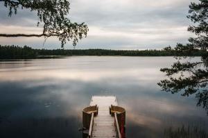 a dock in the middle of a large lake at PihlasResort in Joroinen