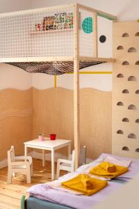 a bedroom with a bunk bed and a table at Sopociaki in Sopot +12 photos
