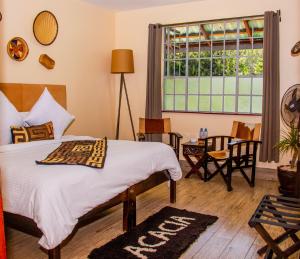 a bedroom with a bed and a window at Acacia Tree Lodge in Nairobi