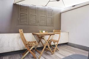 a table and two chairs sitting at a bar at Dash Living Rochor in Singapore