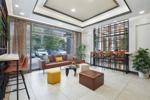 a living room with a couch and a table at Dash Living Rochor in Singapore