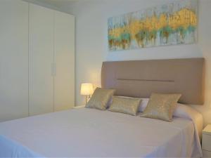 a bedroom with a large white bed with two pillows at La perla del mar 2 in Son Servera