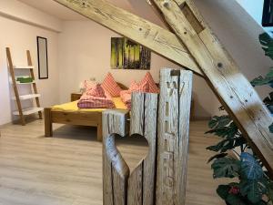 a room with a bed with a wooden heart in the middle at Haus Jehle in Görwihl