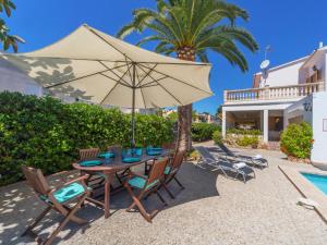 a patio with a table with an umbrella and chairs at Villa Antonio in Palma de Mallorca