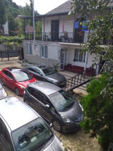 a group of cars parked in front of a house at Family Hotel "Big House" in Kobuleti