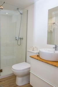 a bathroom with a sink and a toilet and a shower at Florasol Residence Hotel - Dorisol hotels in Funchal