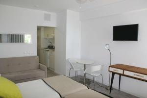 a small room with a bed and a table and chairs at Florasol Residence Hotel - Dorisol hotels in Funchal