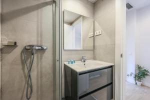 a bathroom with a sink and a shower at AmazINN Places Blasco de Garay 102 in Madrid
