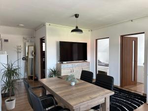 - une salle à manger avec une table et des chaises en bois dans l'établissement Bokorlak 3, à Odorheiu Secuiesc