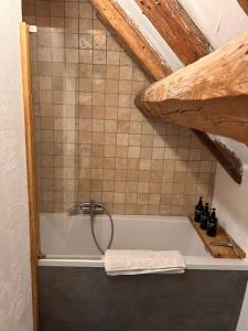 a bath tub with a shower in a bathroom at EnJOiE in La Garde