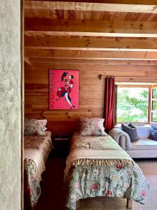 sypialnia z 2 łóżkami w drewnianym domku w obiekcie EnJOiE w mieście La Garde