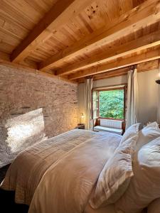 a bedroom with a large bed with a wooden ceiling at EnJOiE in La Garde