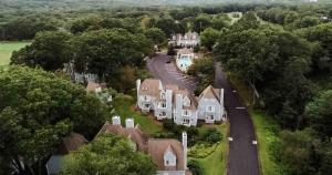 an aerial view of a house with a road and trees at Villa Signor in Norwich