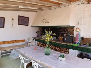 a room with a table with a vase of flowers on it at La Quibla de Abuhan in Caudé
