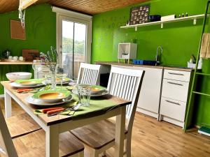 a kitchen with green walls and a table and chairs at Natur Atempause Schwarzwald in Horb am Neckar +13 photos