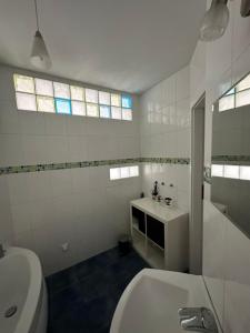 a white bathroom with a sink and a toilet at Apartament Centrum in Zielona Góra