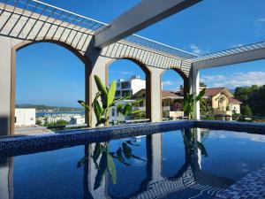 a swimming pool in a house with a view of the water at Benzen villa in Nha Trang