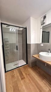 a bathroom with a glass shower and a sink at Centro Storico Caruggi 2min Acquario Pellicceria Superior Loft Palazzo Rolli in Genova