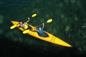 two people in a yellow kayak in the water at Kalpitiya Chalets by Thilanka in Kalpitiya