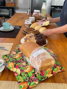 a table with a long loaf of bread on a plate at Pousada & Hospedagem Estação in Domingos Martins