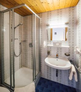 a bathroom with a shower and a sink at Hotel Komperdell in Serfaus