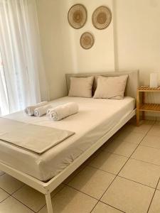 a bed with two pillows on it in a room at Casa D'oro A1 in Larisa