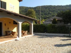 a patio of a house with a bird sitting on the ground at Tenuta Armida Relax & Pool in Liberi