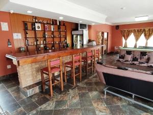 a bar in a restaurant with red walls at Acre of Africa Guesthouse in Boksburg