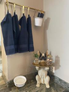 a dog standing in a bathroom with a tray of food at Good Morning Karlstad City in Karlstad