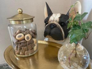 a glass jar with a dog on top of a table at Good Morning Karlstad City in Karlstad