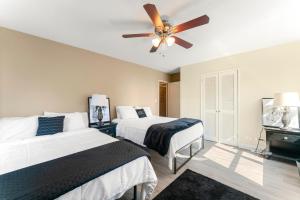 a bedroom with two beds and a ceiling fan at 17th floor Luxxe Penthouse Downtown ATL in Atlanta