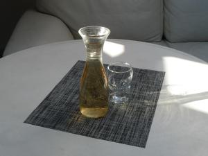 a vase sitting on a table next to a glass at Apartment Studio Loft Ekaterina in Tbilisi City +13 photos