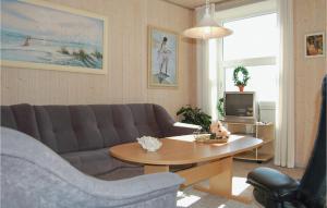 a living room with a couch and a table at 2 Bedroom Gorgeous Home In Hvide Sande in Havrvig