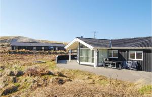 a house on the side of a field at Gorgeous Home In Hvide Sande With Sauna in Hvide Sande